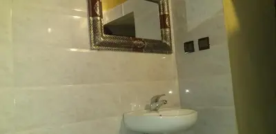 a bathroom with a sink and a mirror at Camping Bassou in Nkob