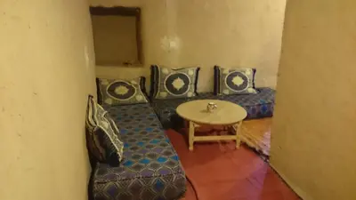 a living room with a couch and a table at Camping Bassou in Nkob