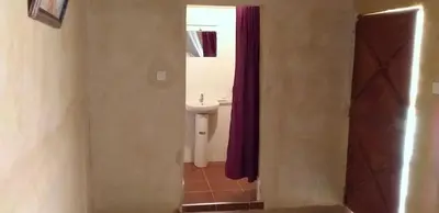 a bathroom with a sink and a mirror at Camping Bassou in Nkob