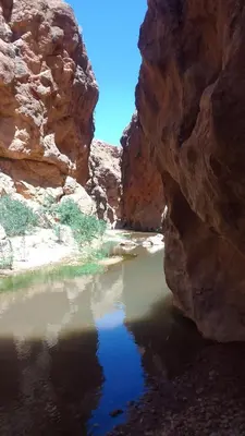 a pool of water in the middle of a canyon at Maison D'hote Amazir DADES in Boumalne