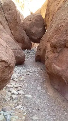 a group of rocks in a canyon with a dirt road at Maison D'hote Amazir DADES in Boumalne