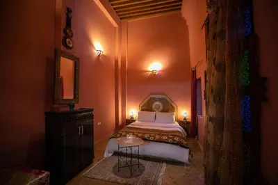 a bedroom with a bed and a table in it at Dar Mchachti fes in Fès