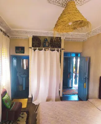 a bedroom with a bed and a ceiling at Le petit Jardin in Demnat