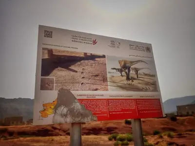 a sign in the middle of the desert at Le petit Jardin in Demnat