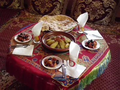 a table with a bowl of food on a table at LE JARDIN DES GRENADIERS in Skoura