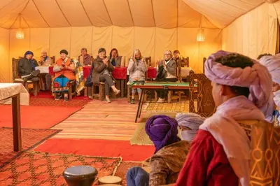 a group of people sitting in a tent at Dihya desert camp in Merzouga