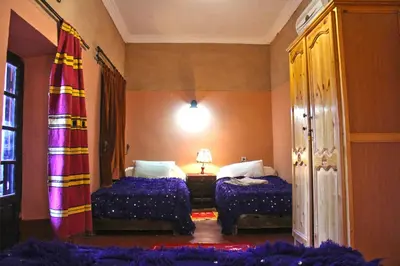 a hotel room with two beds and a window at Chez Yacob kasbah in Agdz