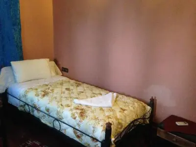 a bedroom with a bed with a towel on it at Chez Yacob kasbah in Agdz
