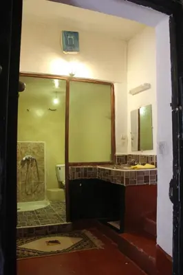 a bathroom with a sink and a toilet and a mirror at Chez Yacob kasbah in Agdz
