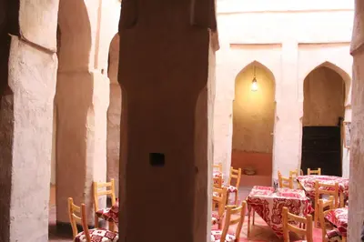 a room with tables and chairs in a building at Chez Yacob kasbah in Agdz