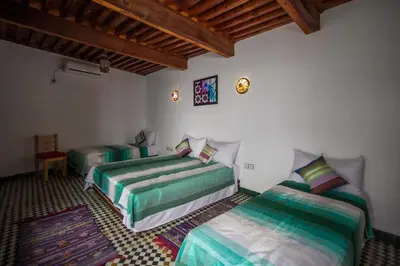a bedroom with two beds in a room at DAR MILOUDA RCIF in Fès