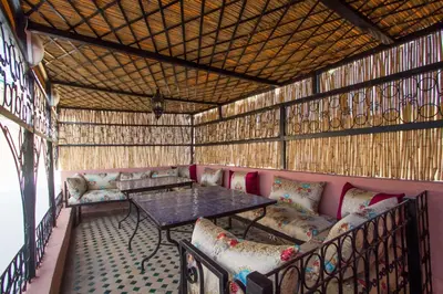 a room with a table and chairs in a building at DAR MILOUDA RCIF in Fès
