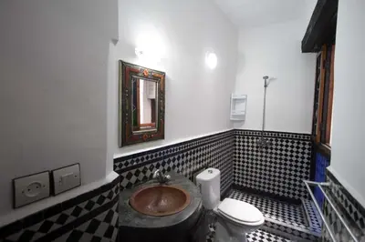 a bathroom with a toilet and a sink at DAR MILOUDA RCIF in Fès