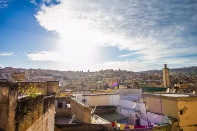a view of a city from the roofs of buildings at DAR MILOUDA RCIF in Fès
