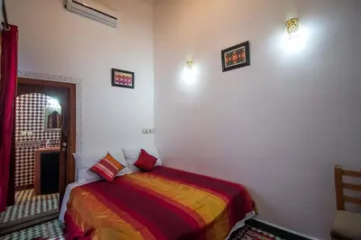 a bedroom with a bed in a room at DAR MILOUDA RCIF in Fès