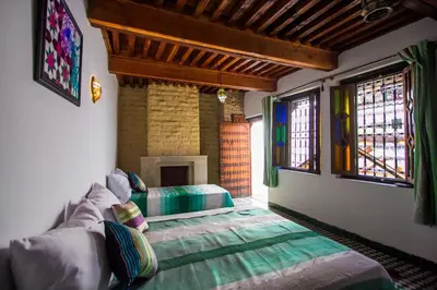 a living room with a couch and windows at DAR MILOUDA RCIF in Fès