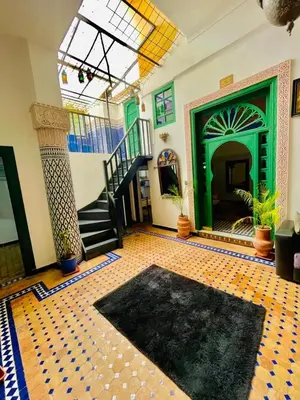 a living room with a staircase and a tile floor at Dar Jardin Majorelle Fez in Fès