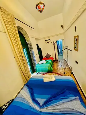a bedroom with a large blue bed in a room at Dar Jardin Majorelle Fez in Fès