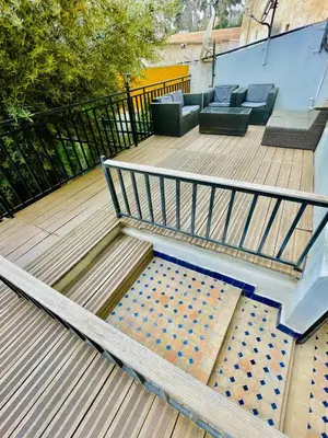 a set of stairs leading to a patio with couches at Dar Jardin Majorelle Fez in Fès