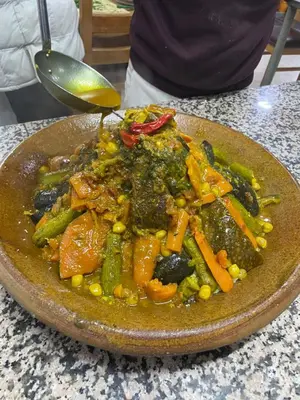 a large bowl of food on a table at Hotel Meteorites Boulaajoul in Zaida