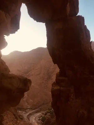 a view of a canyon from a cave in the desert at Auberge Le Festival Todra Gorge in Aït Baha