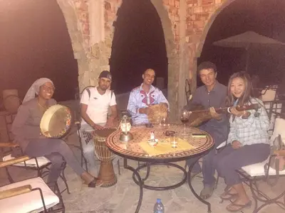 a group of people sitting around a table at Auberge Le Festival Todra Gorge in Aït Baha