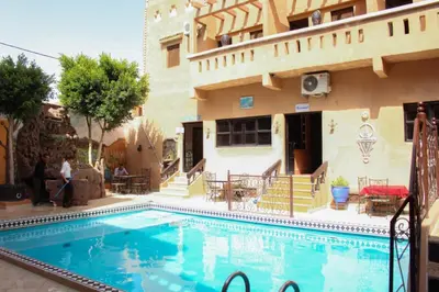 a swimming pool in front of a building at La Rose De Sable in Aït Ben Haddou