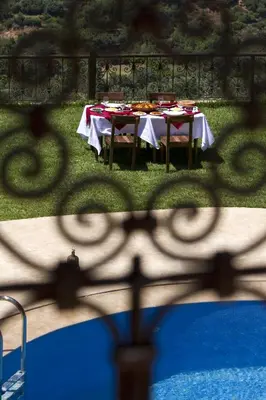 a table set up for a meal through a fence at Kasbah Illy in Demnat