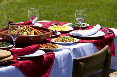 a table with plates of food and glasses of wine at Kasbah Illy in Demnat