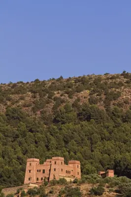 an old building on the side of a mountain at Kasbah Illy in Demnat