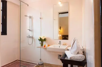 a white bathroom with a sink and a shower at Hapimag Resort Marrakesh in Douar Soukkane