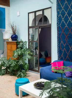 a living room with a blue couch and a table at Dar anne in Fès