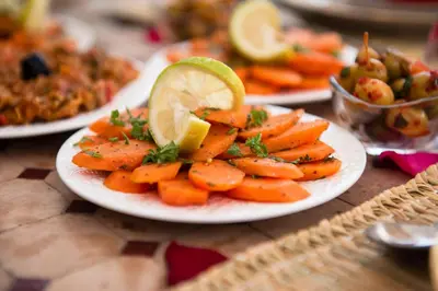 a plate of carrots with a lime slice on it at Dar anne in Fès