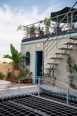 a house with a blue door and stairs on it at Dar anne in Fès