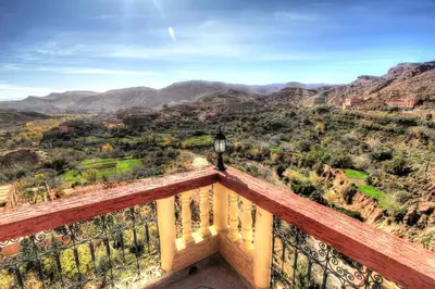 a view of the mountains from the balcony of a building at Dar Essyaha in Ait Ben Ali