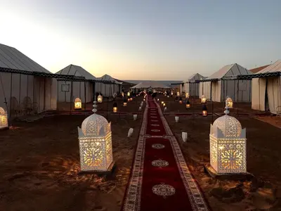 a group ofented tents with candles in them at Camp Sahara Majestic in Mhamid