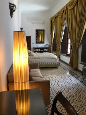 a living room with a couch and a bed at Riad Meyssane Fès in Fès