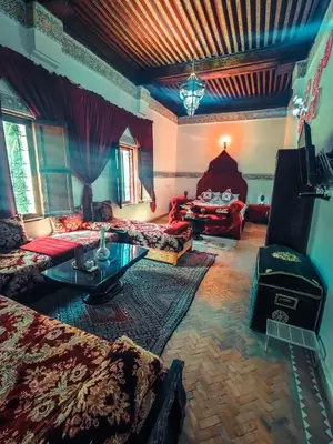 a large living room with couches and a table at Ryad Zahrat Fes in Fès
