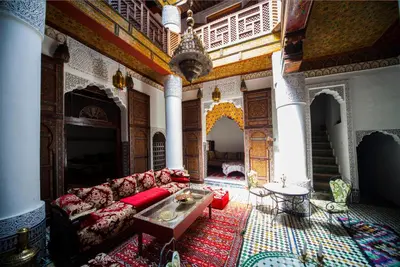 a living room with a couch and a table at Ryad Zahrat Fes in Fès