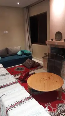 a living room with a couch and a table at Le Chêne d´Azrou in Azrou