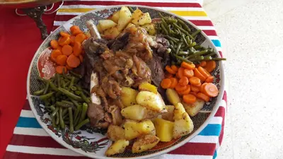 a plate of food with meat and vegetables on a table at Le Chêne d´Azrou in Azrou