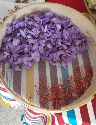 a bowl filled with purple flowers on a table at Le Chêne d´Azrou in Azrou