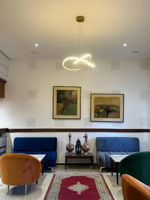 a waiting room with two blue couches and a ceiling at Hotel Splendid in Fès