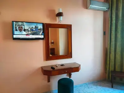 a bathroom with a mirror and a tv on the wall at Hotel Splendid in Fès