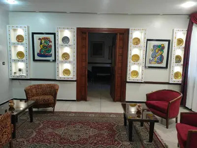 a room with chairs and paintings on the walls at Hotel Splendid in Fès