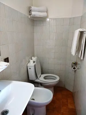 a bathroom with a white toilet and a sink at Hotel Splendid in Fès