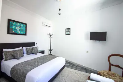 a bedroom with a bed and a tv on the wall at Cine House in Fès