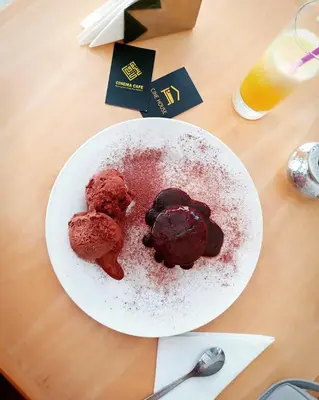 a white plate with chocolate cookies on a table at Cine House in Fès