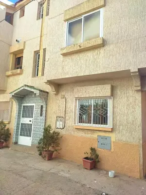 a building with a door and a sign in front of it at sweet Atlas hollydays in Azrou