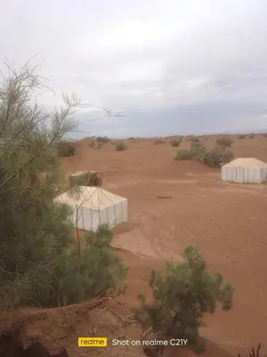 two white tents in the middle of a desert at Desert Atmosphere M'Hamid in Mhamid